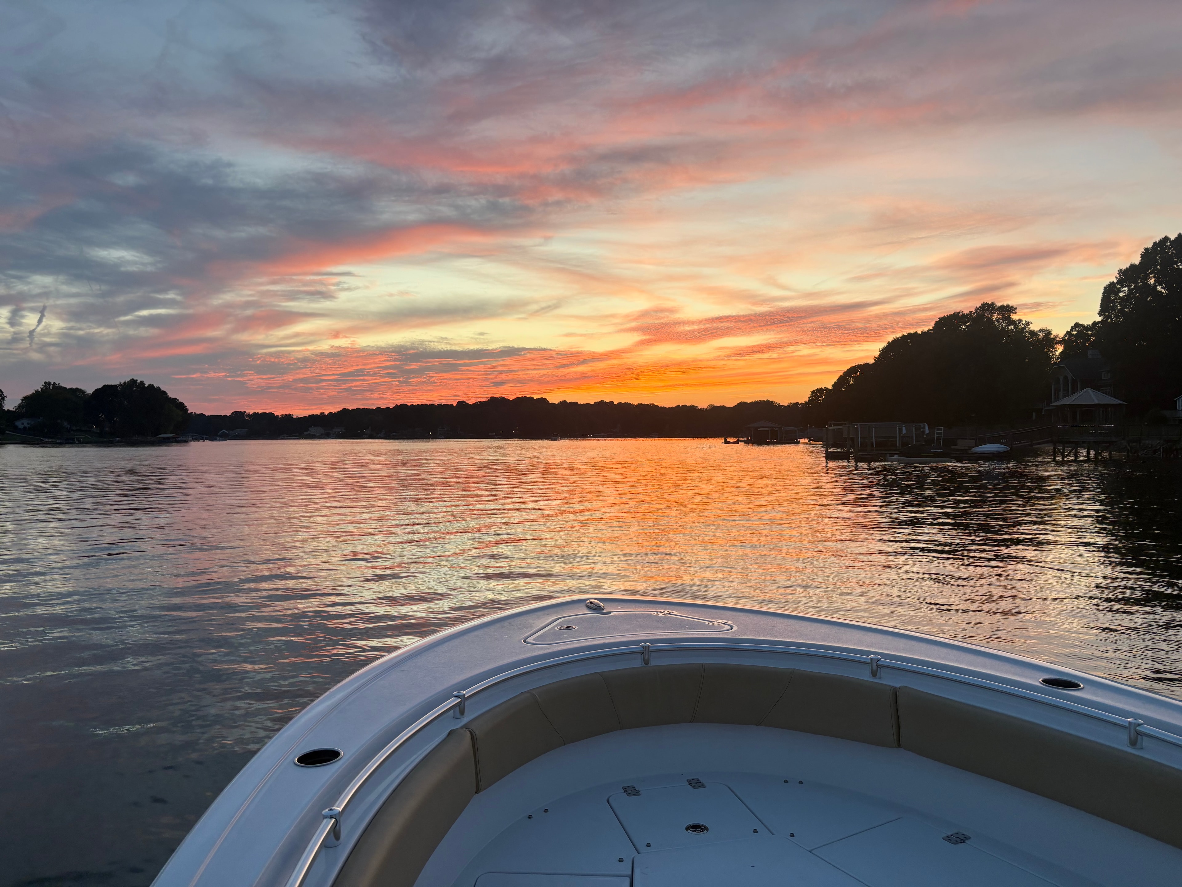 Sportsman 231 bow under a dramatic orange and pink sunset sky