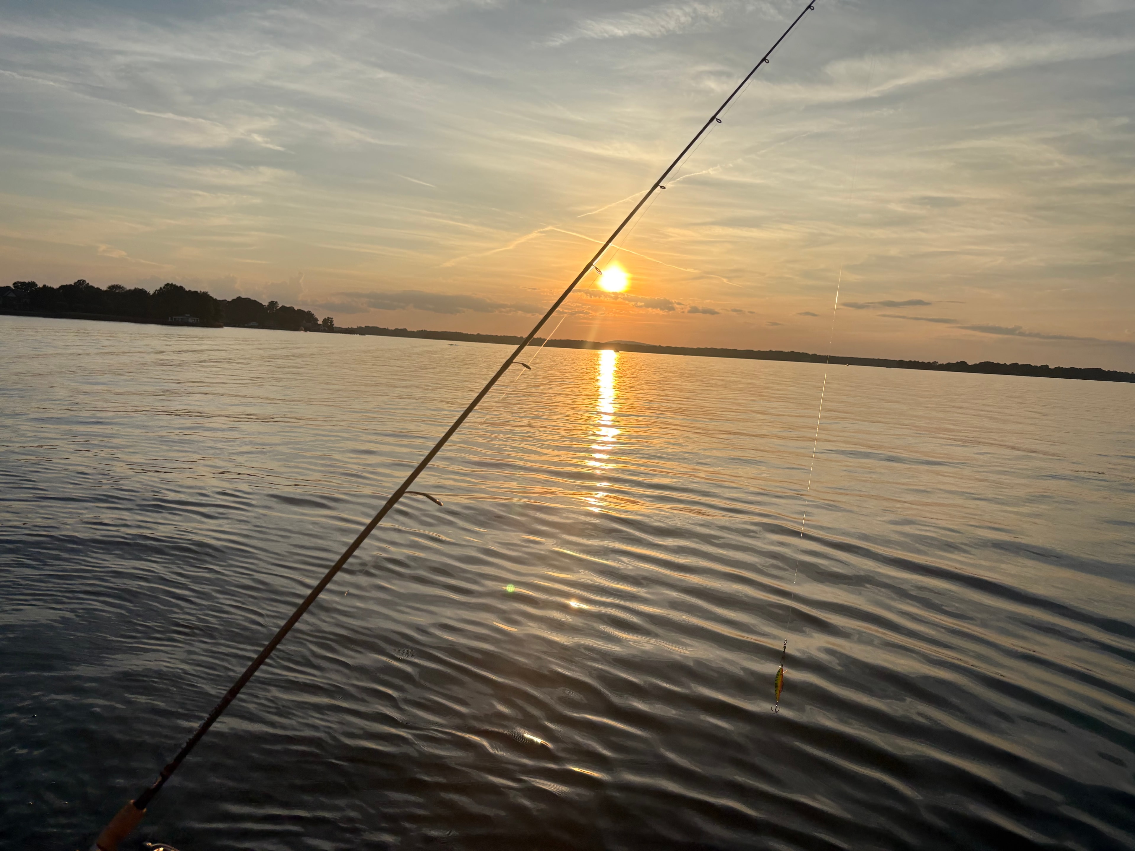 Fishing rod against a golden Lake Norman sunset