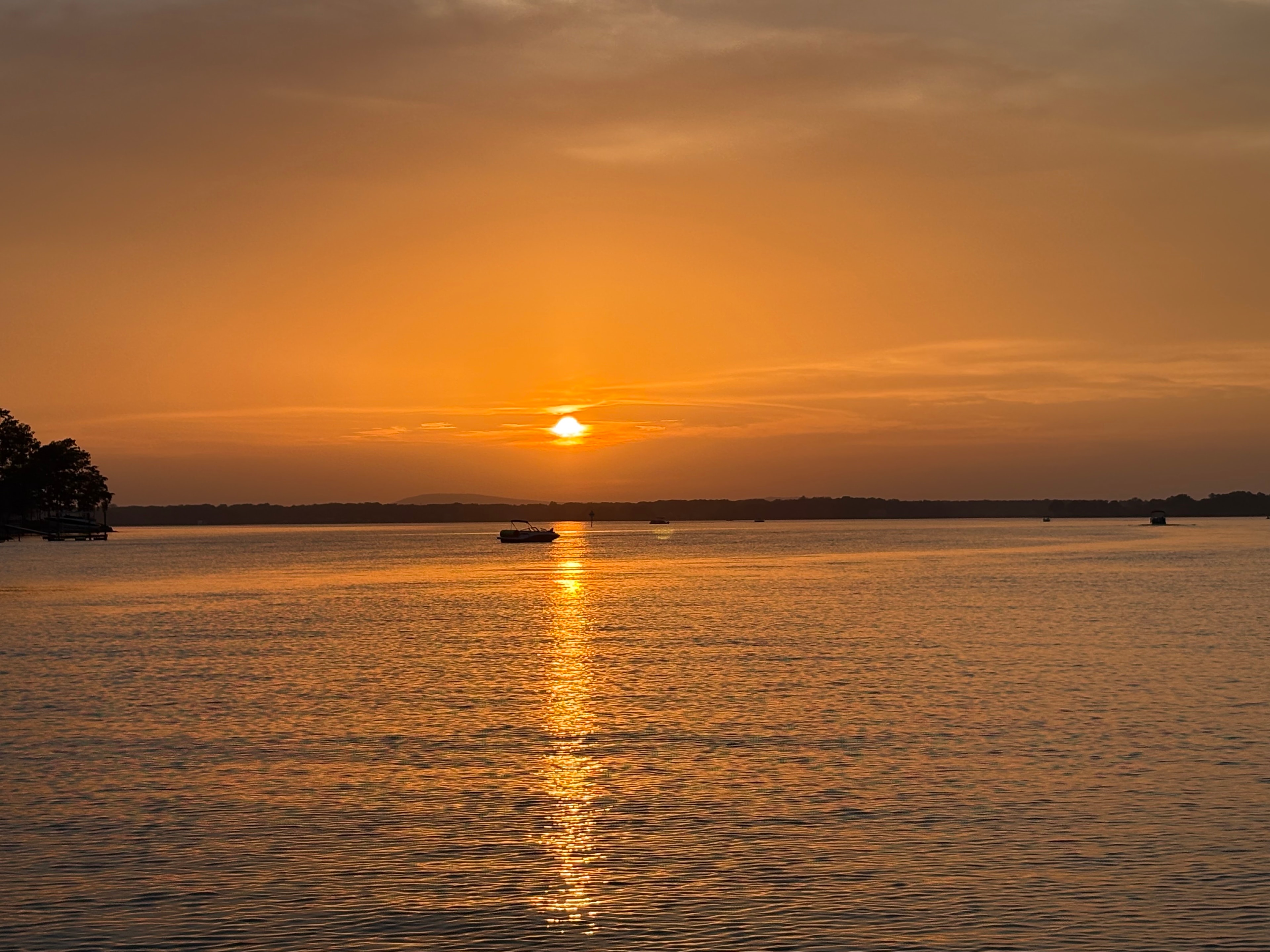 Deep golden sunset over open Lake Norman water
