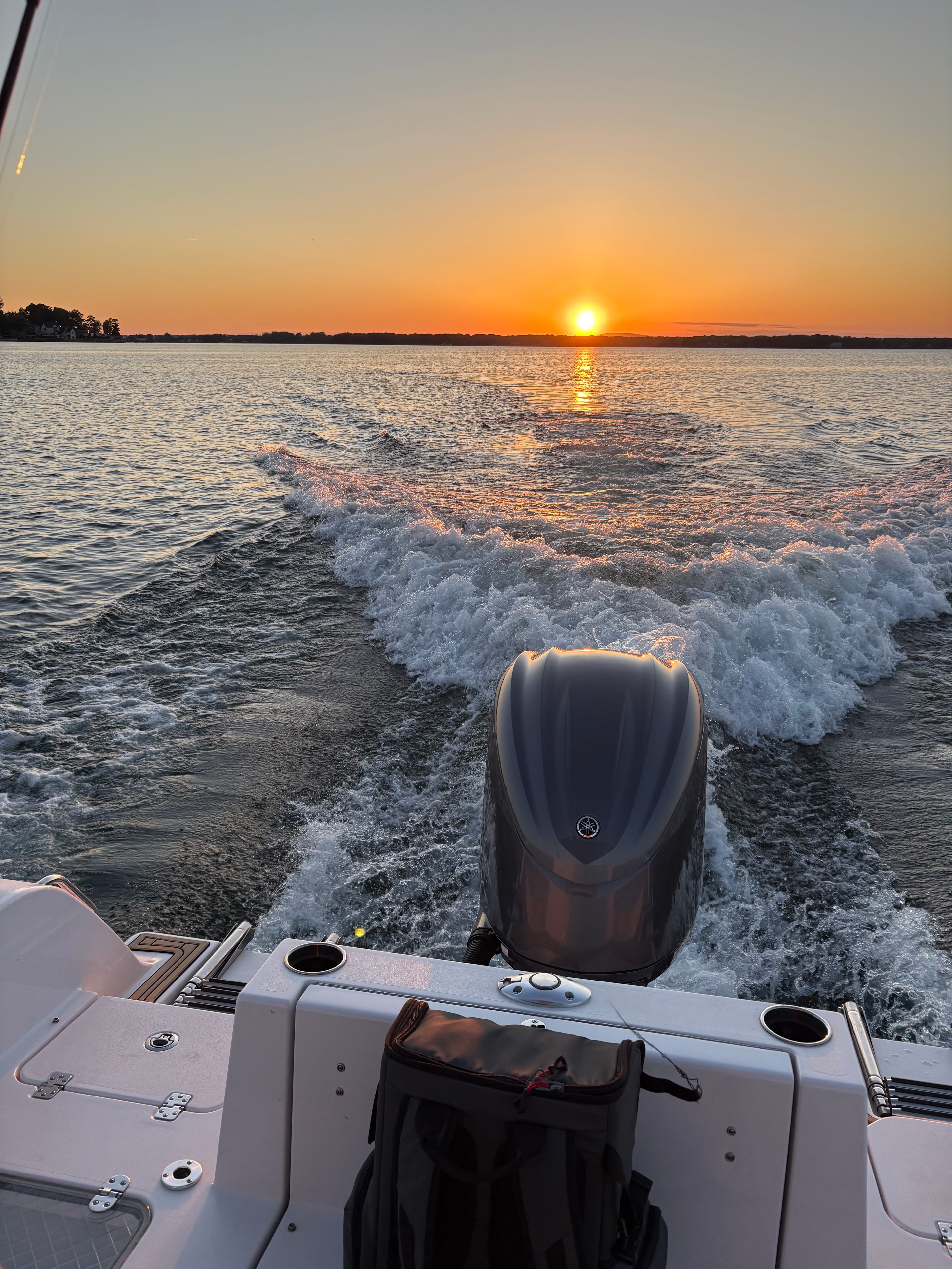 Yamaha 300 engine and wake trail at sunset on Lake Norman
